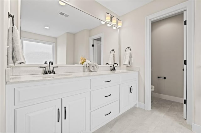 bathroom featuring tile patterned flooring, vanity, and toilet