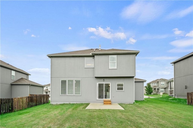 back of property featuring a yard and a patio