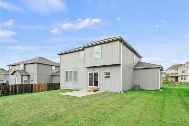 back of property featuring a lawn, a patio, and central AC unit