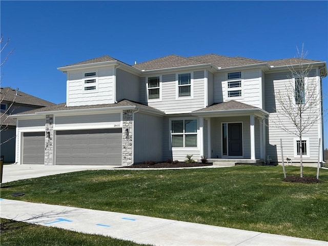 prairie-style house featuring a front lawn and a garage