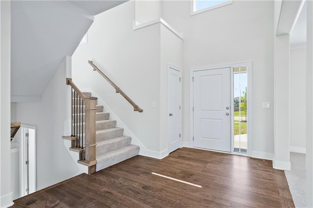 entrance foyer featuring dark hardwood / wood-style flooring and high vaulted ceiling