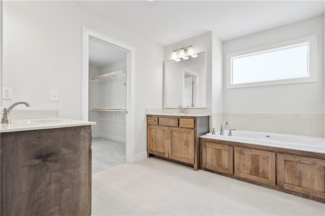 bathroom with vanity, tile patterned floors, and a bathing tub