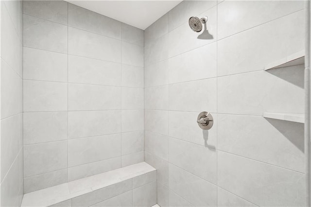 bathroom with a tile shower