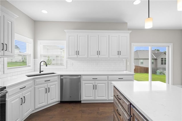 kitchen with hanging light fixtures, white cabinetry, appliances with stainless steel finishes, and sink