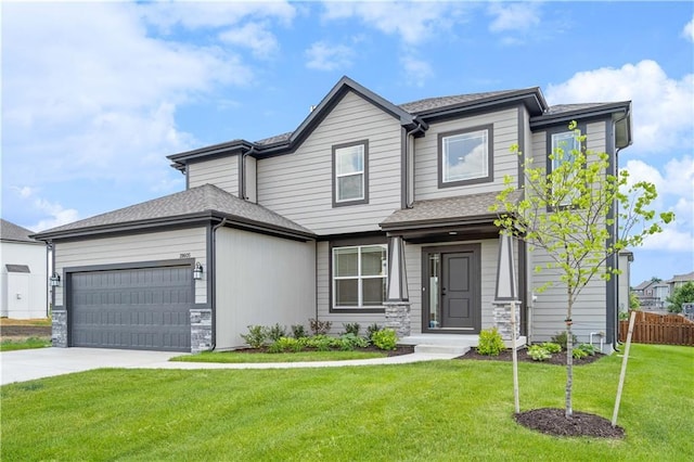 view of front of home with a garage and a front yard