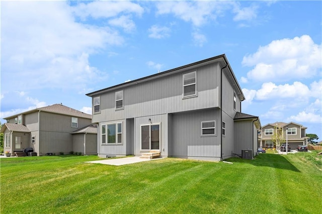 rear view of property featuring central AC, a patio area, and a lawn