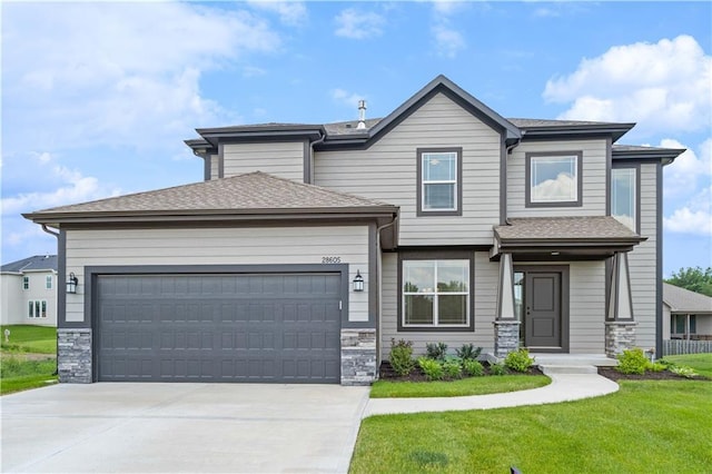 view of front of home with a garage and a front yard