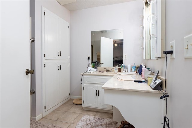 bathroom featuring tile patterned flooring and vanity