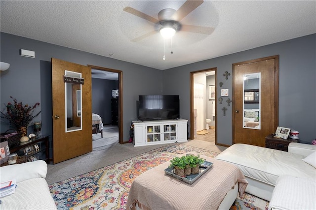 carpeted living room with a textured ceiling and ceiling fan