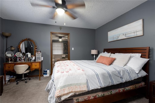 carpeted bedroom with ceiling fan and a textured ceiling