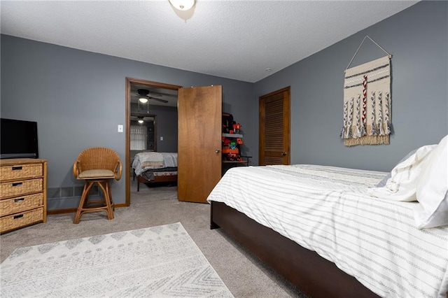 carpeted bedroom featuring a textured ceiling and a closet