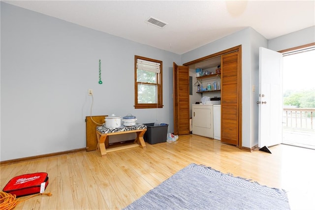 interior space featuring washer and clothes dryer and hardwood / wood-style flooring