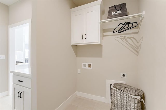 laundry room featuring cabinets, light tile patterned floors, hookup for a washing machine, and electric dryer hookup