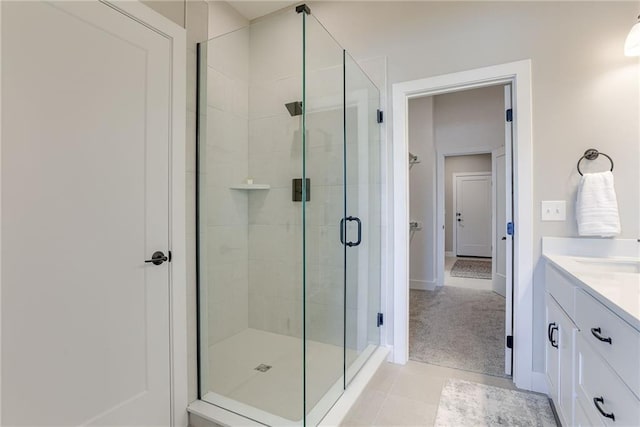 bathroom with vanity, tile patterned flooring, and a shower with door