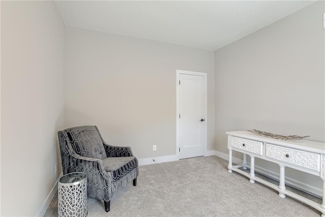 sitting room featuring light carpet