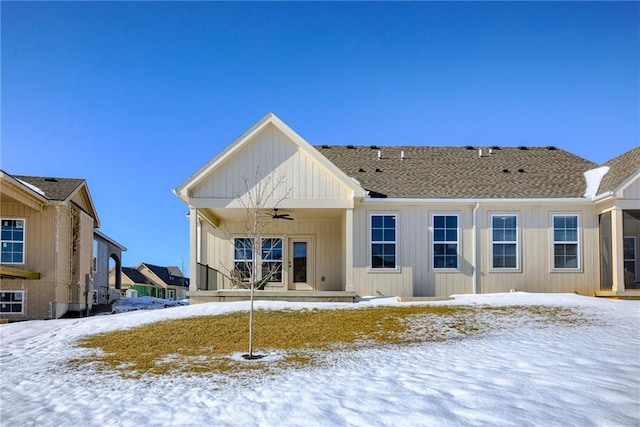 snow covered house featuring ceiling fan