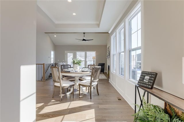 dining area featuring ceiling fan and light wood-type flooring