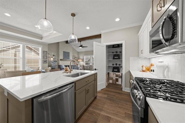 kitchen featuring sink, dark wood-type flooring, decorative light fixtures, white cabinets, and appliances with stainless steel finishes