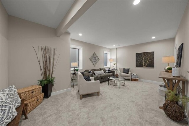 living room featuring light carpet and beamed ceiling