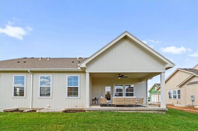 rear view of property featuring outdoor lounge area, ceiling fan, a patio area, and a yard