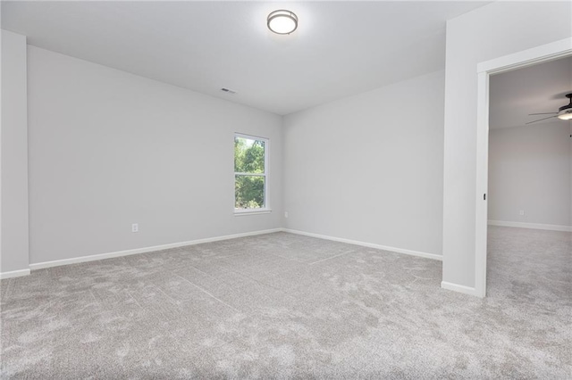 empty room with ceiling fan and carpet floors