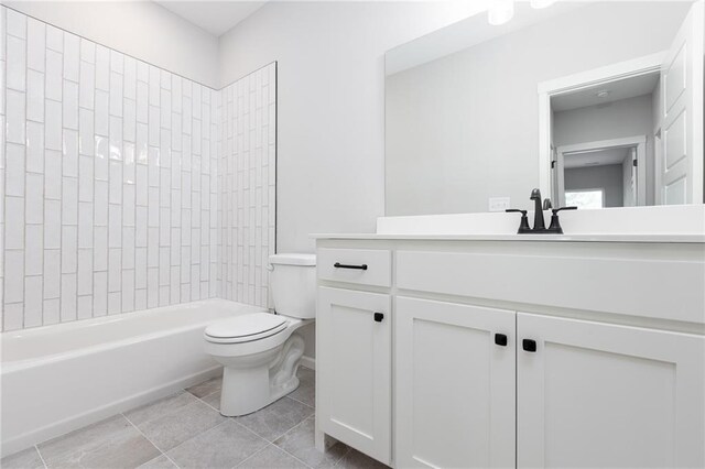 full bathroom featuring vanity, tiled shower / bath, tile patterned flooring, and toilet