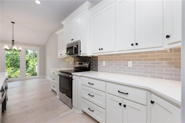 kitchen with light hardwood / wood-style flooring, lofted ceiling, white cabinetry, backsplash, and stainless steel appliances