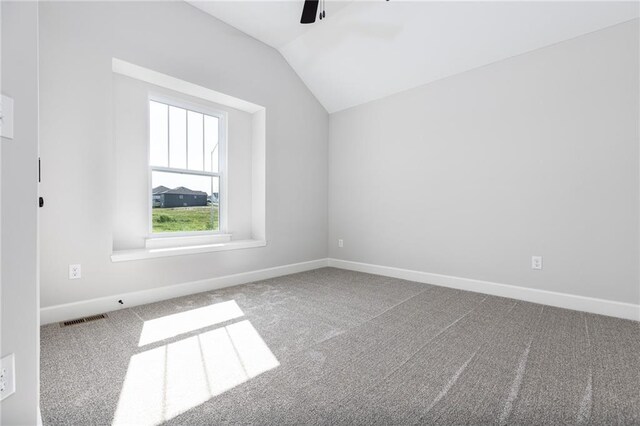 carpeted empty room with ceiling fan and lofted ceiling