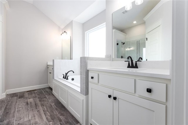 bathroom with vanity, plus walk in shower, lofted ceiling, and hardwood / wood-style flooring