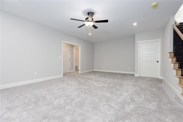 empty room with ceiling fan and carpet floors