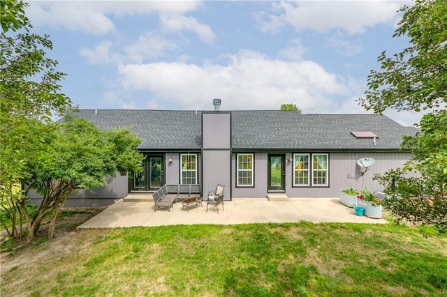 back of house with a lawn and a patio area