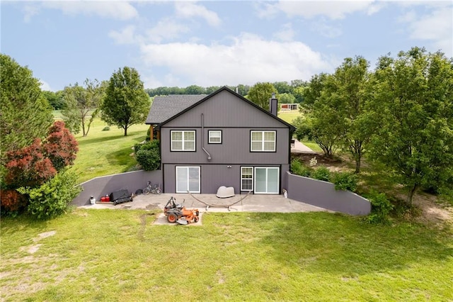 rear view of house with a patio area and a yard