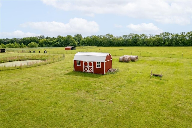 view of yard featuring a rural view and an outdoor structure