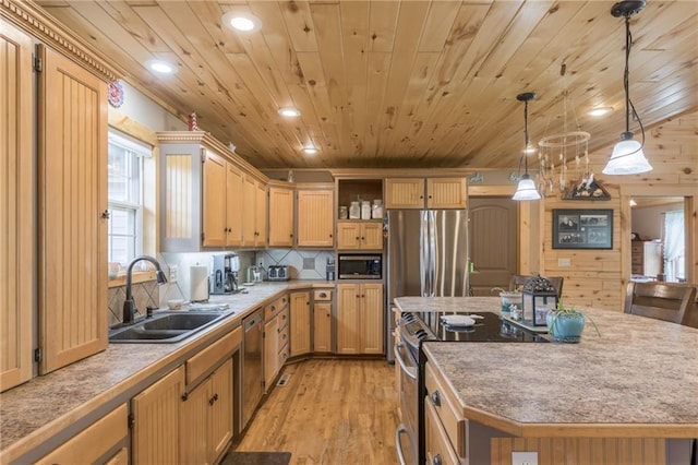 kitchen with sink, a center island, light hardwood / wood-style flooring, pendant lighting, and appliances with stainless steel finishes