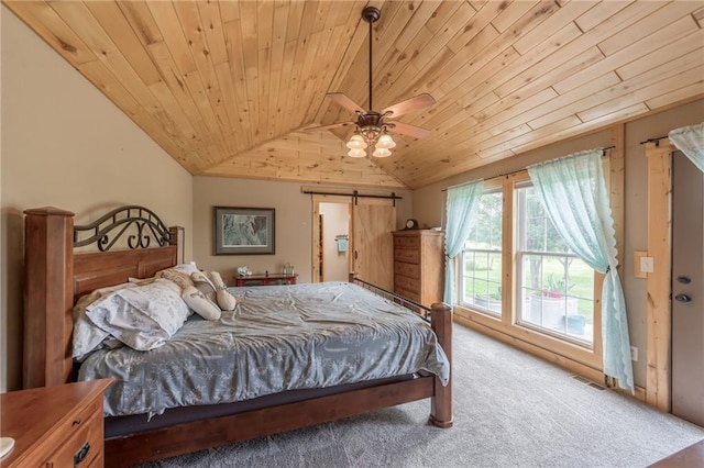 bedroom with carpet floors, vaulted ceiling, ceiling fan, a barn door, and wood ceiling