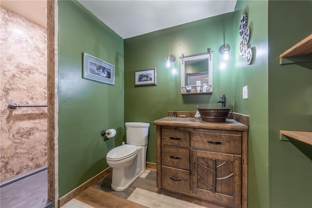 bathroom featuring hardwood / wood-style flooring, vanity, and toilet