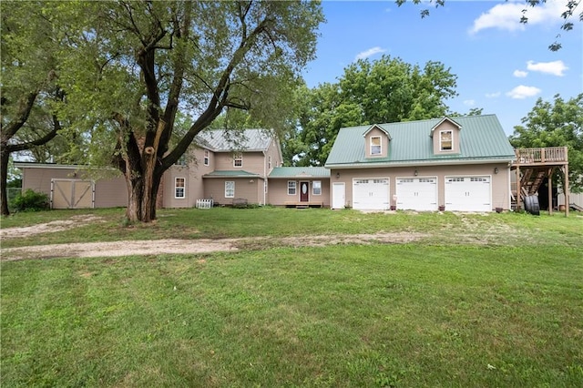 view of front facade featuring a garage, a wooden deck, and a front lawn