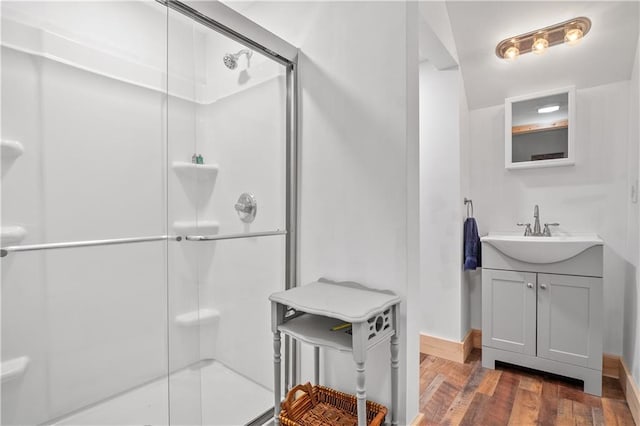 bathroom featuring vanity, hardwood / wood-style floors, and a shower with door