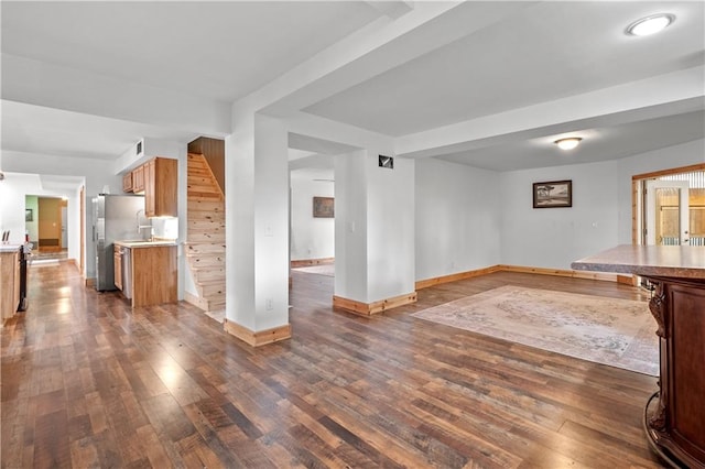 unfurnished living room featuring dark wood-type flooring