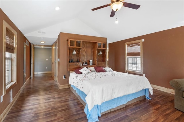 bedroom with vaulted ceiling, ceiling fan, and dark hardwood / wood-style flooring