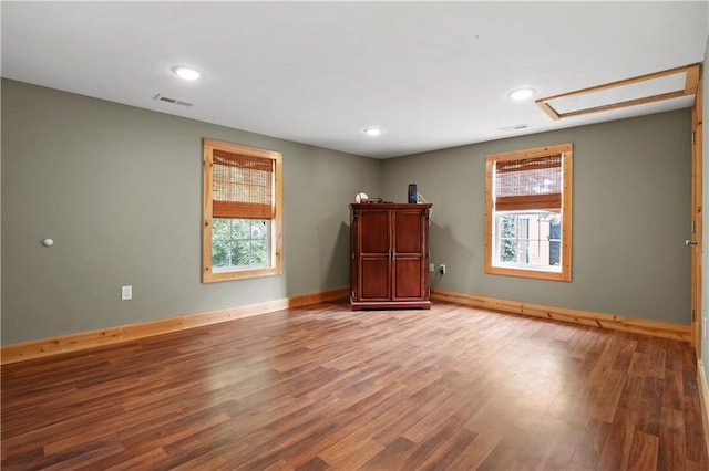 spare room featuring hardwood / wood-style floors and a wealth of natural light