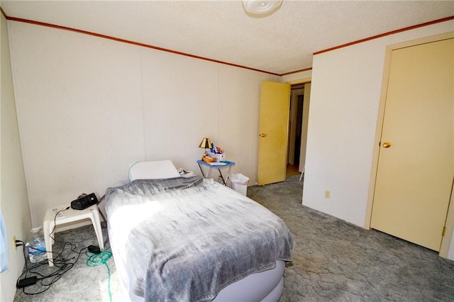 carpeted bedroom with ornamental molding and a textured ceiling