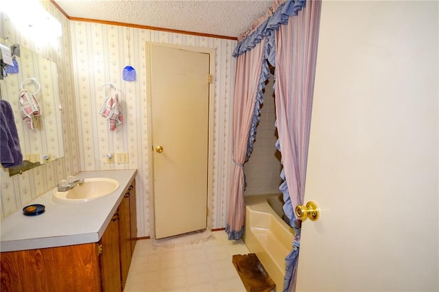 bathroom featuring tile flooring, ornamental molding, vanity, a textured ceiling, and shower / tub combo with curtain