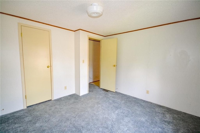 unfurnished bedroom featuring carpet, a textured ceiling, and crown molding