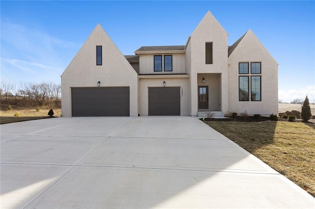 view of front of home with a front yard and a garage