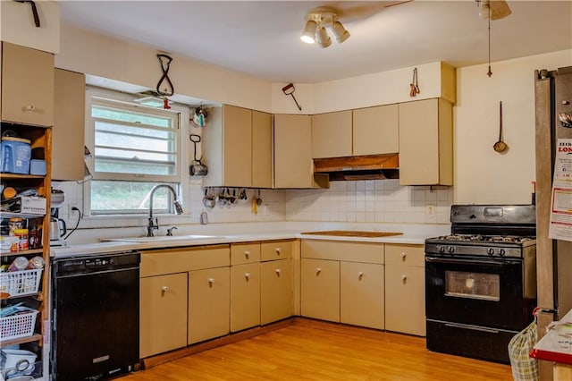 kitchen featuring tasteful backsplash, black appliances, sink, ceiling fan, and light hardwood / wood-style flooring