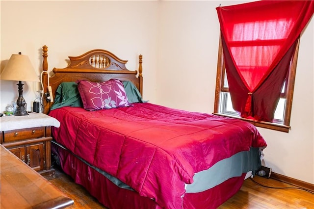 bedroom with dark hardwood / wood-style floors