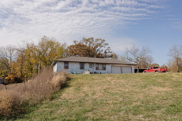 ranch-style home featuring a garage and a front yard