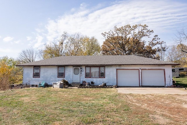 ranch-style home with a garage and a front lawn