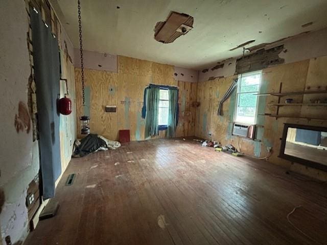 miscellaneous room with cooling unit and wood-type flooring